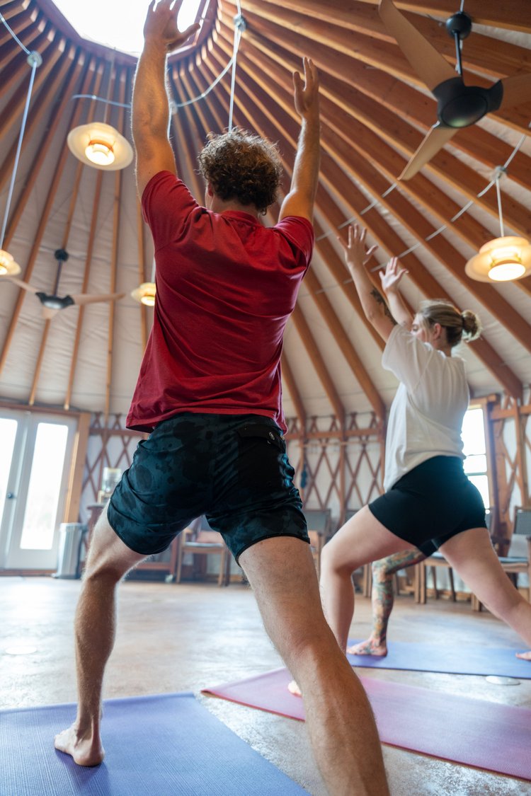 A man and woman doing yoga together