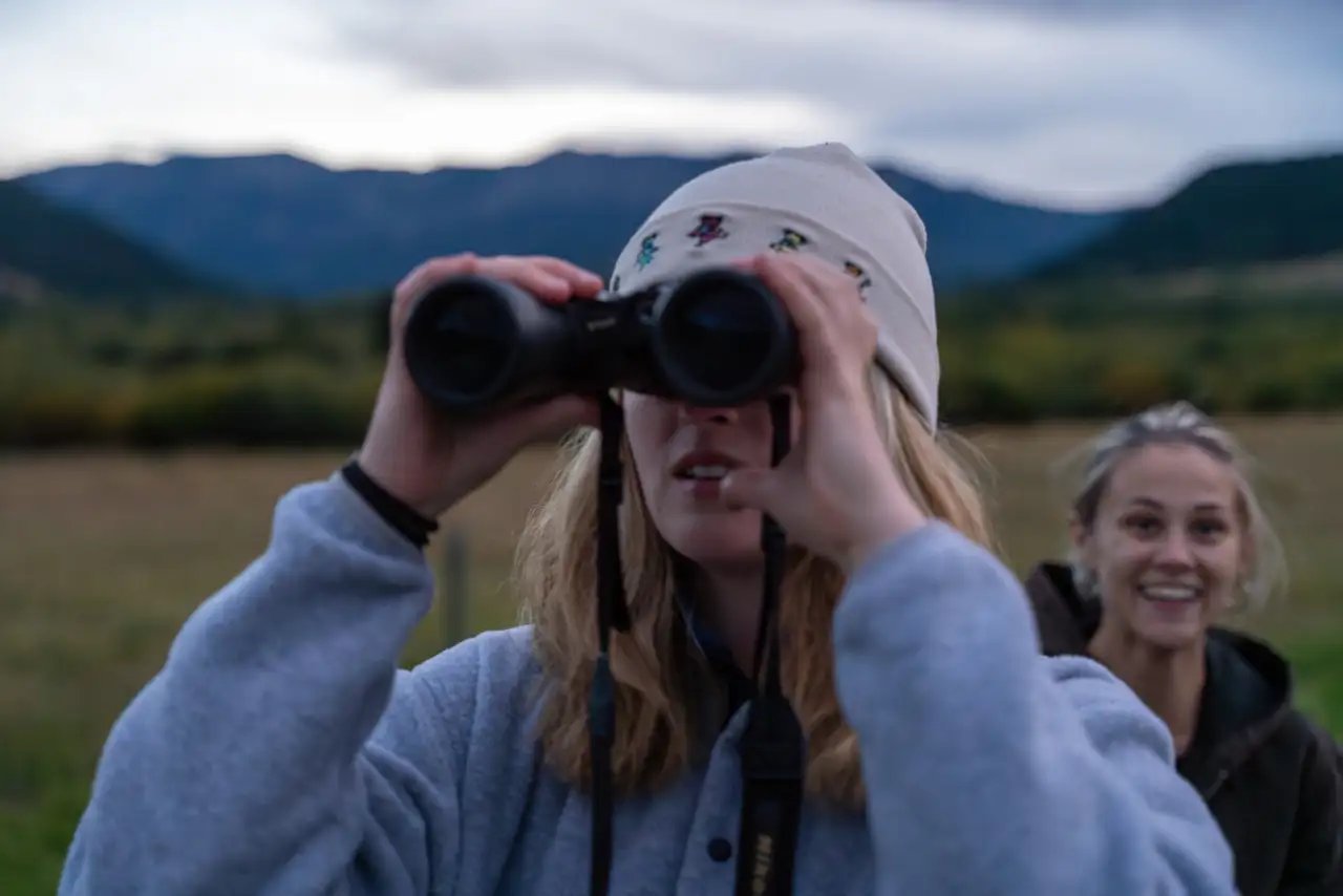 A woman looking through binoculars