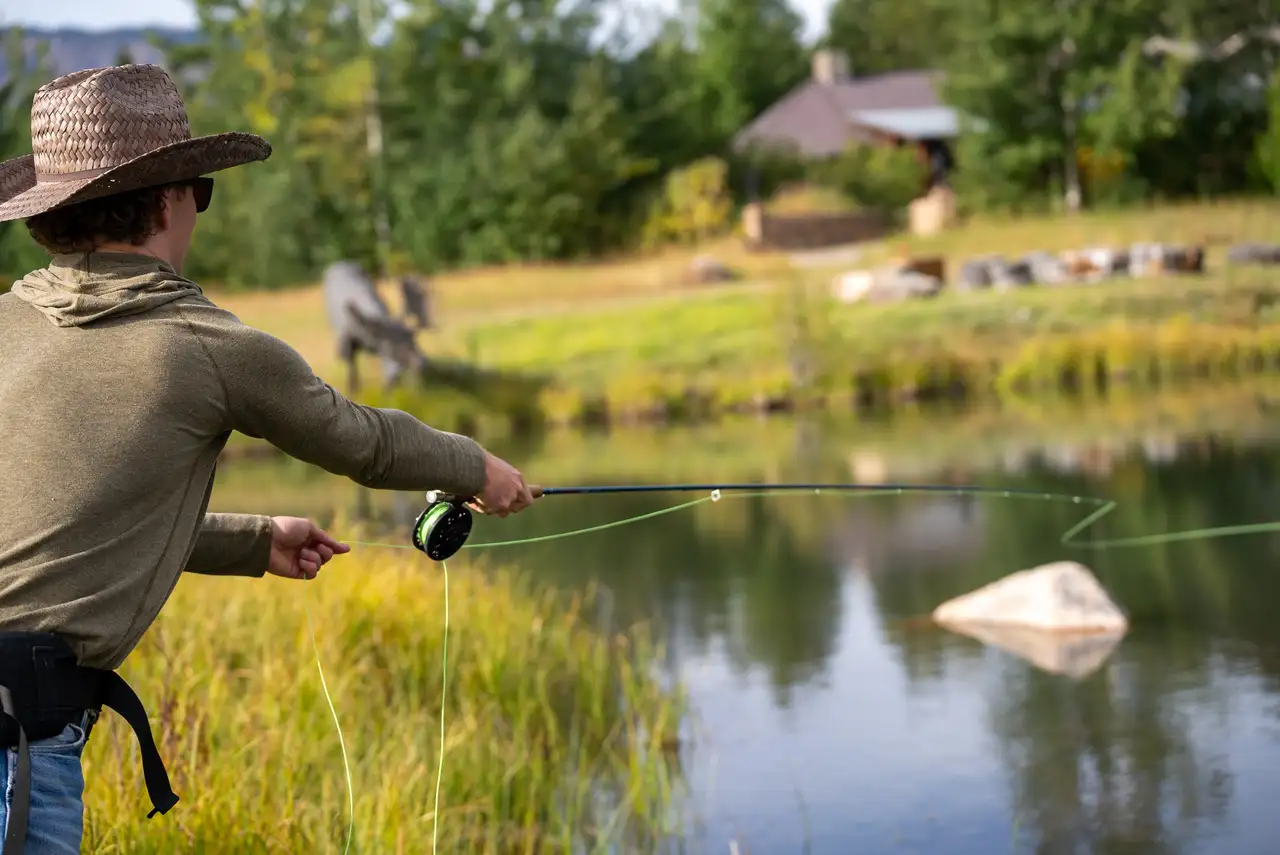 A man is fishing in a pond