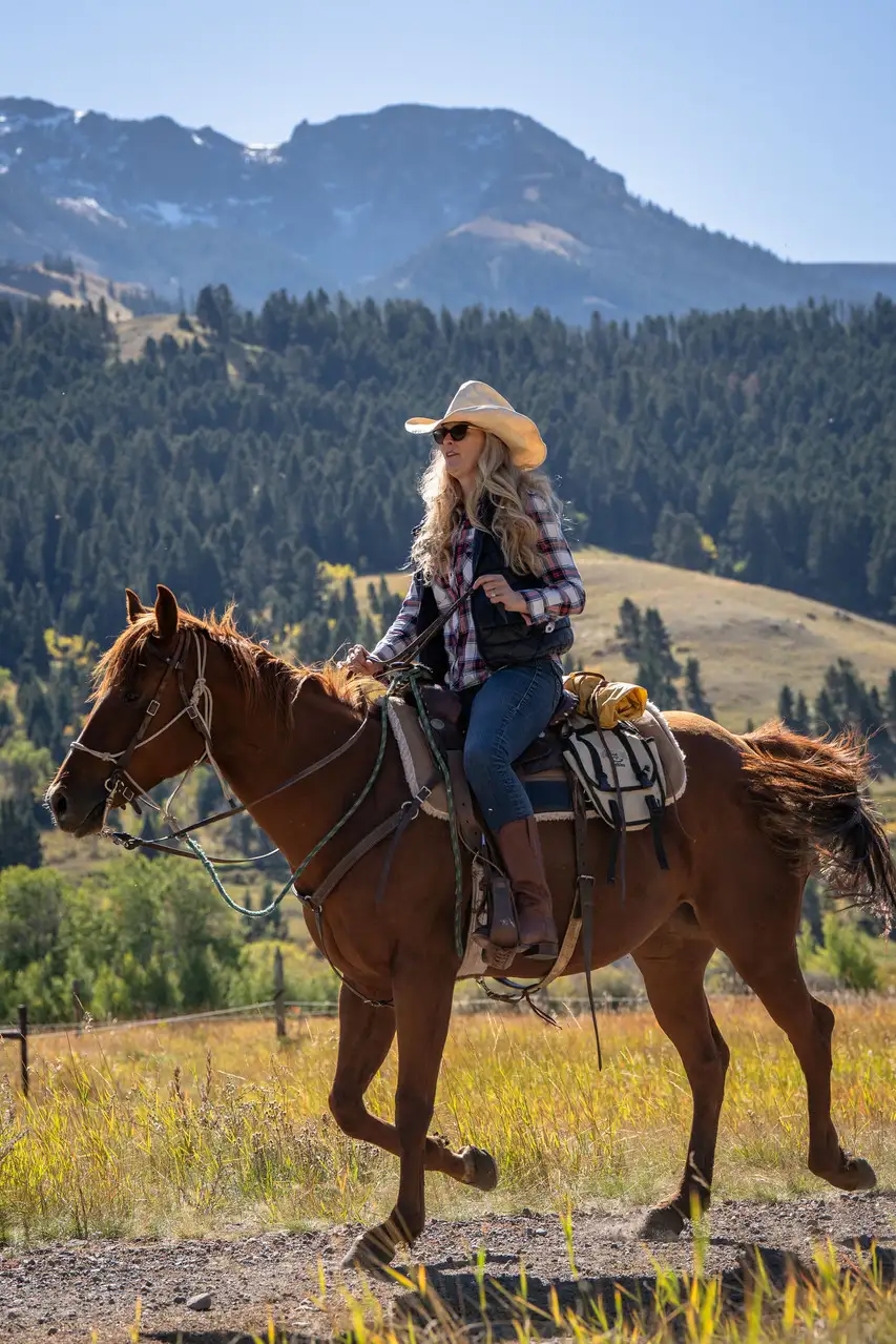 A woman riding a horse in a field