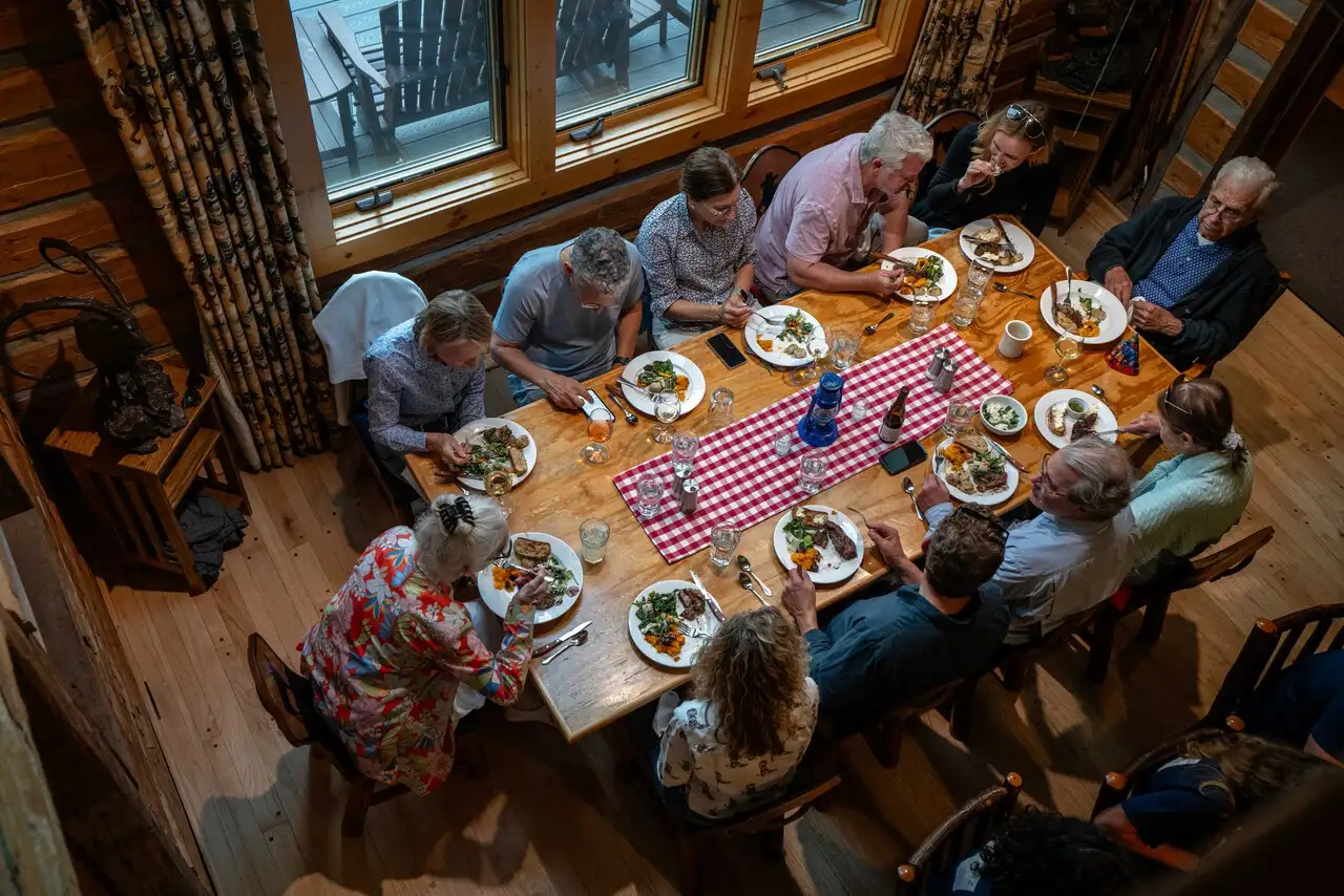 A group of people eating a meal together at a table