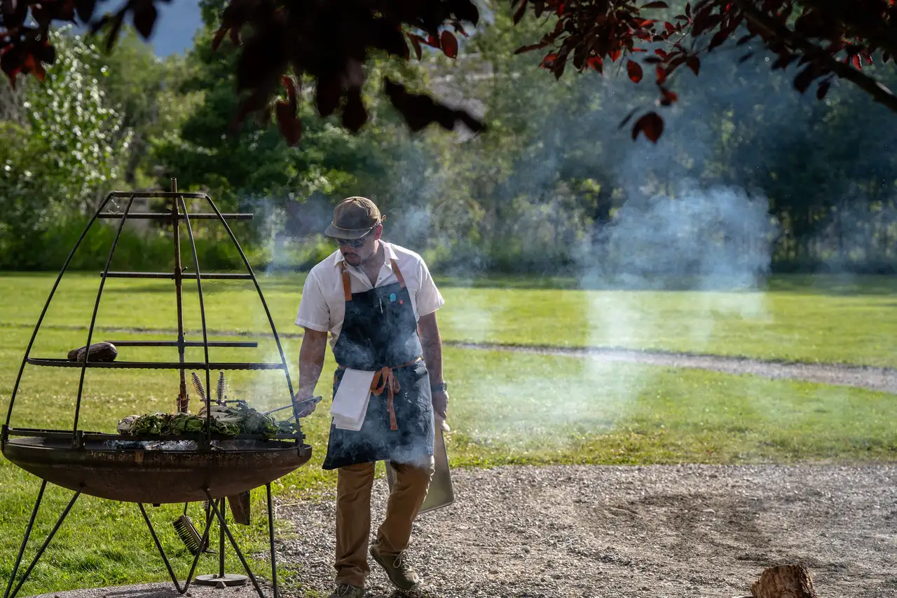 A man cooking food on a grill