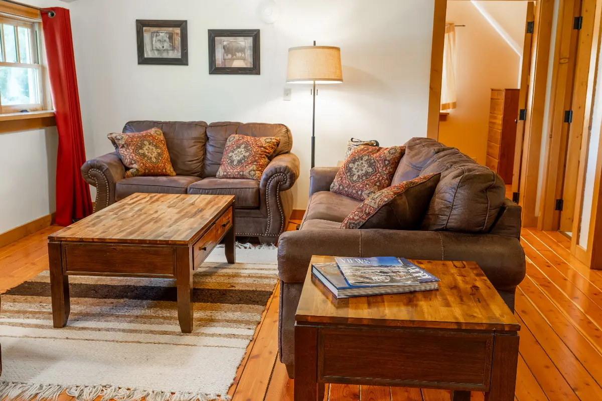 A living room with a couch, coffee table, and lamp