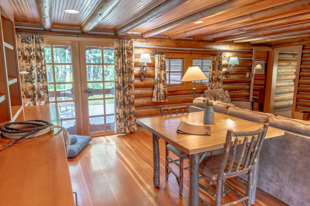 A living room with wooden furniture and a wooden floor