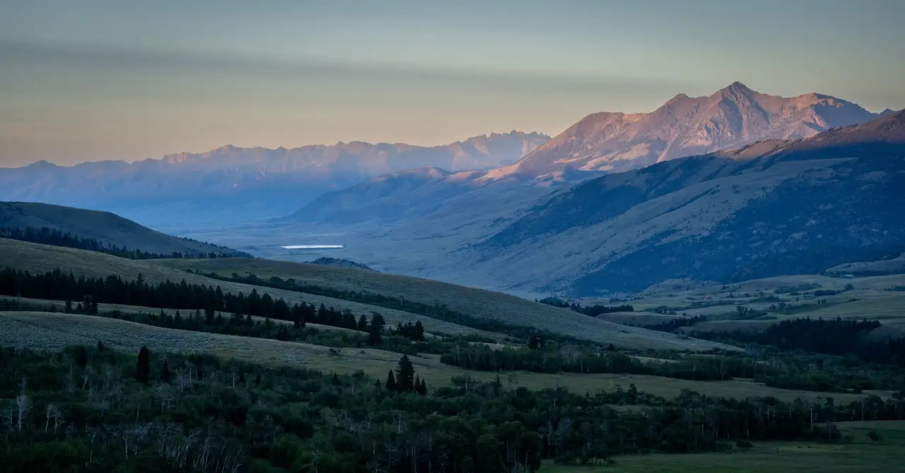 A valley with mountains and a forest