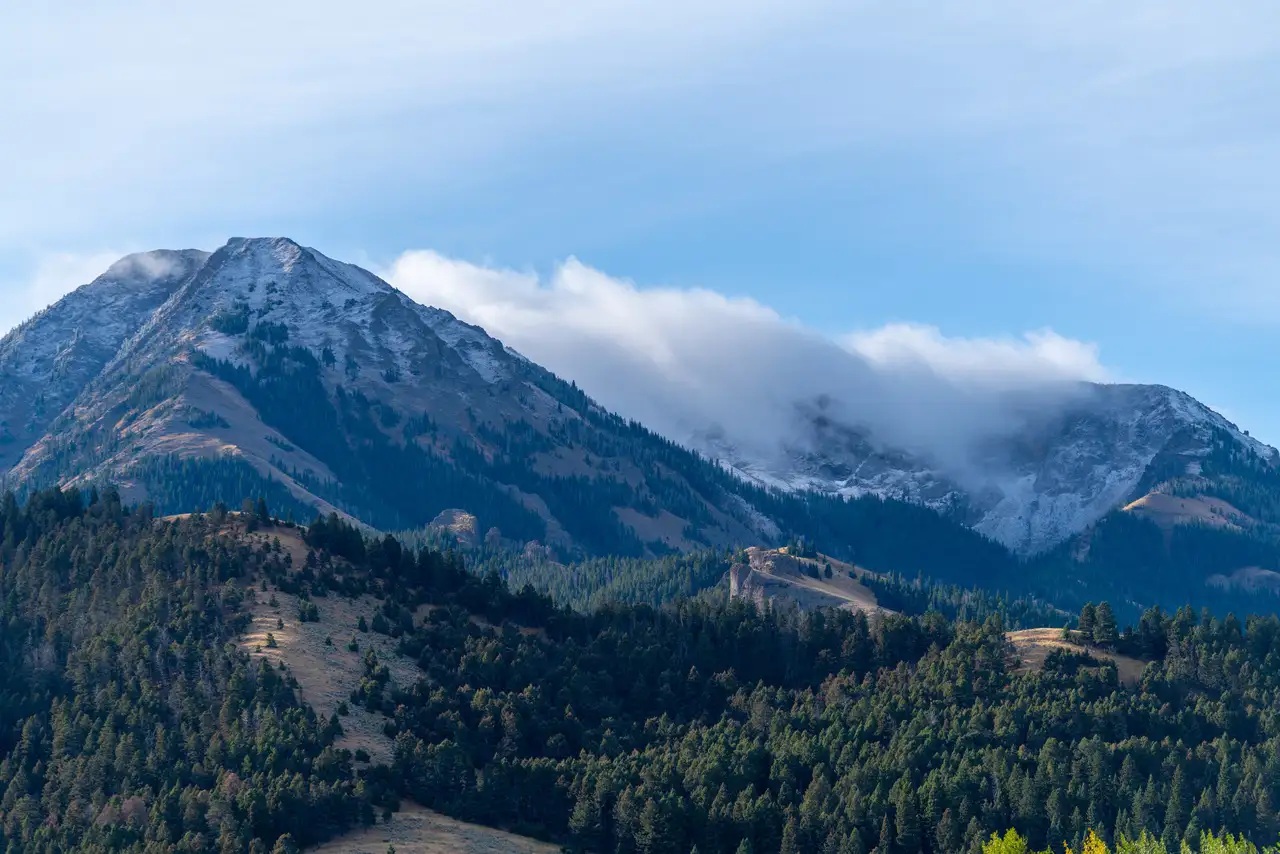 A mountain range with a cloudy sky above it