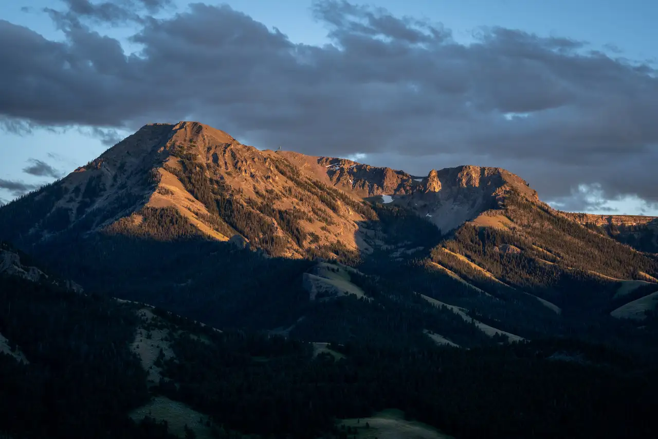 A mountain range with a cloudy sky above it