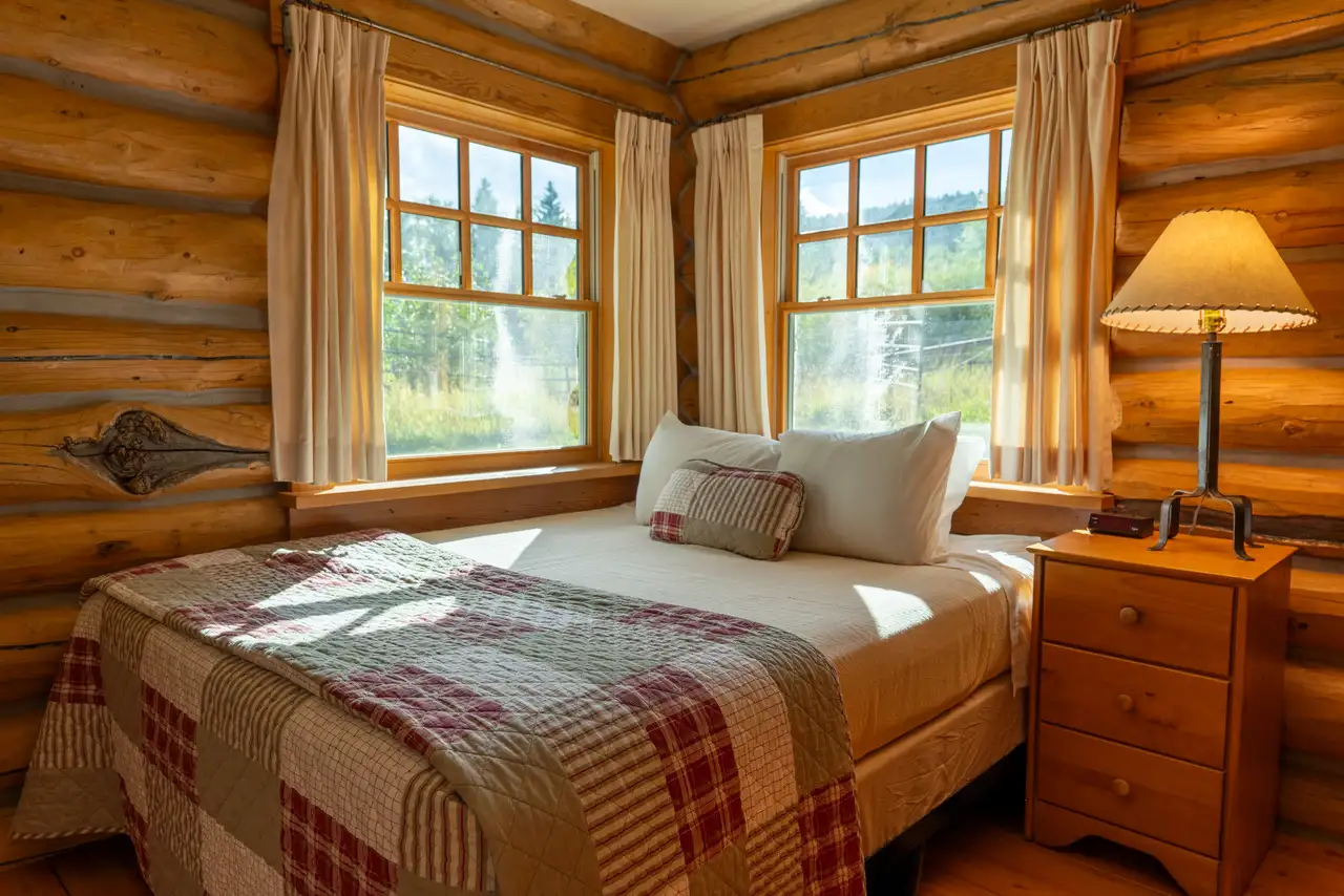 A bedroom with a bed in front of a window