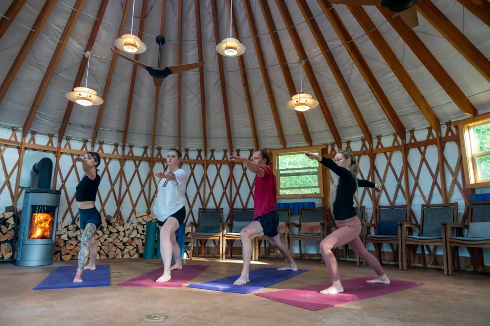 A group of people doing yoga in a round room