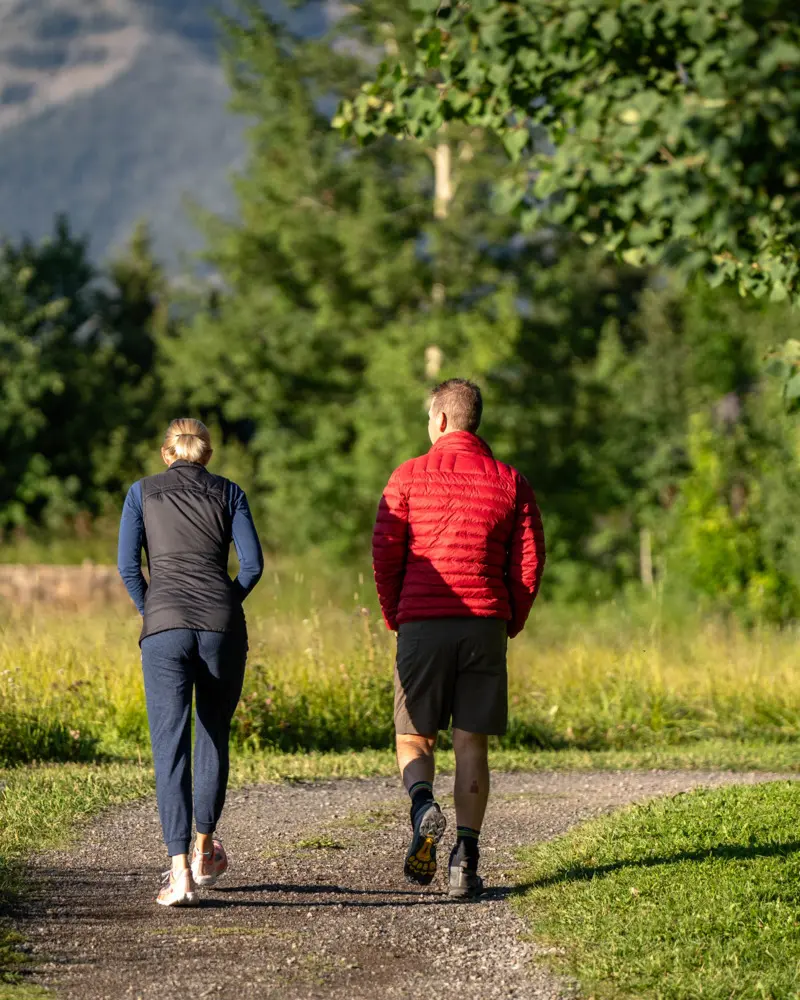 A couple walking on a path in a park