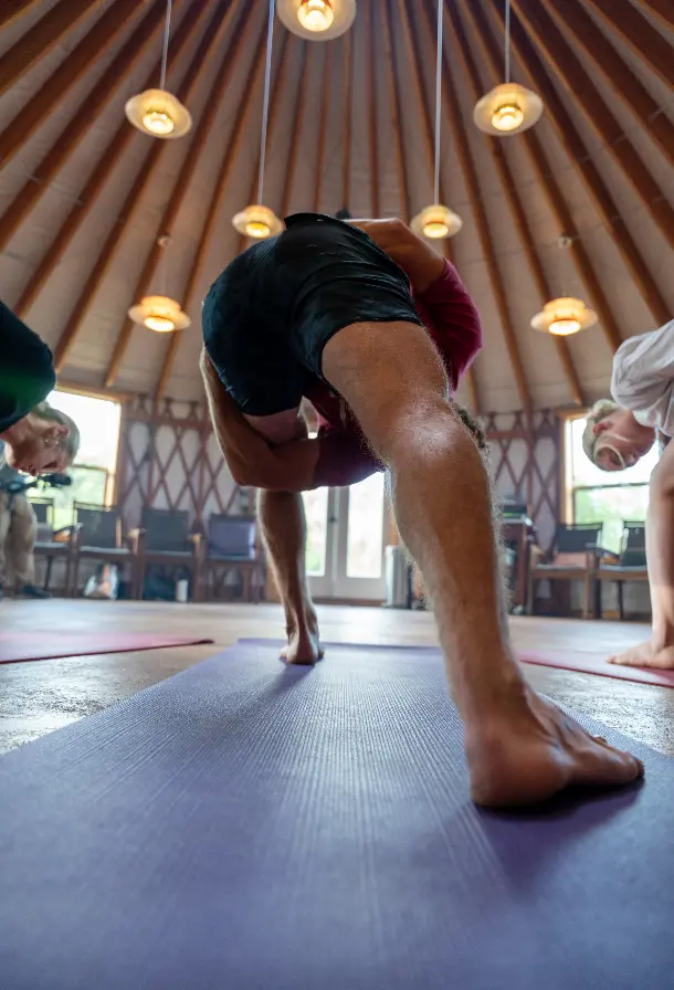 A man doing a yoga pose on a mat