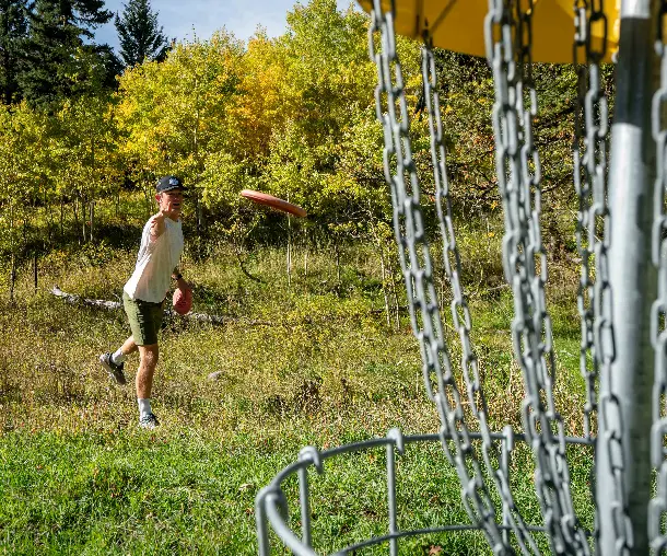 A man throwing a frisbee in a grassy field