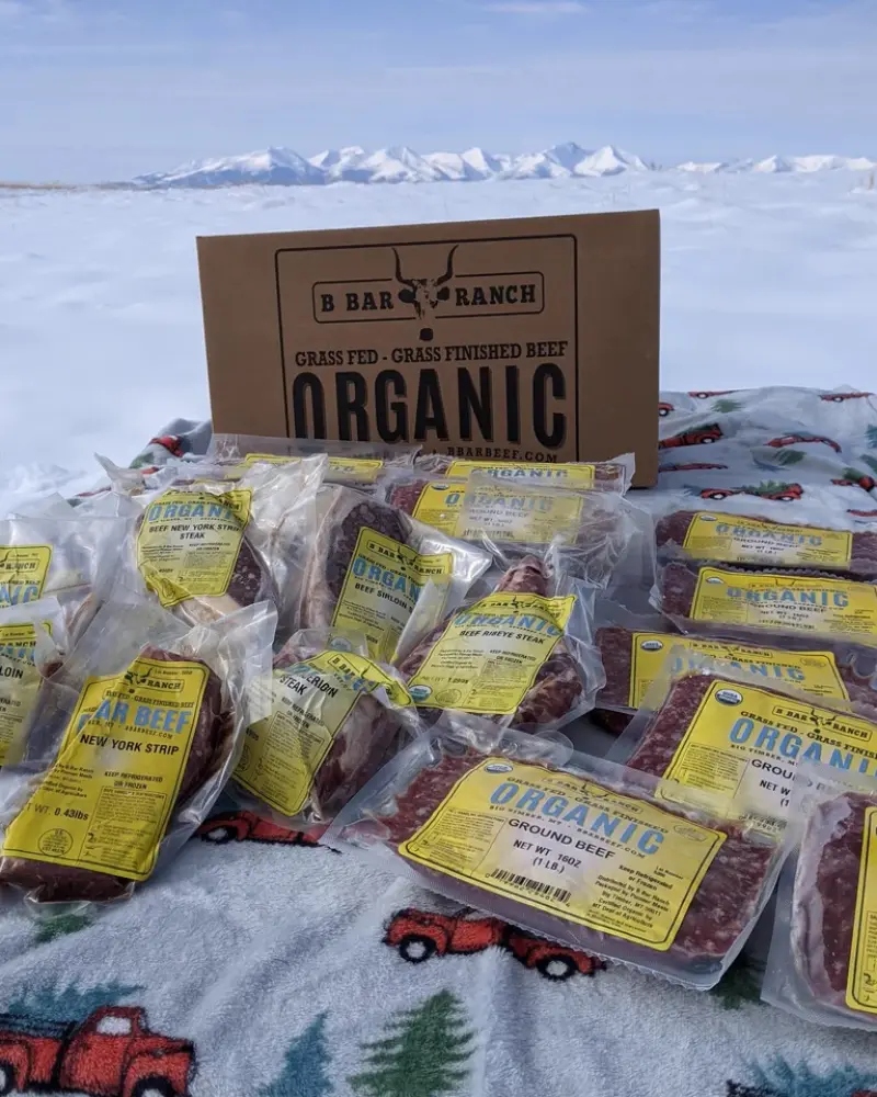 A box of organic beef sits on a blanket in the snow