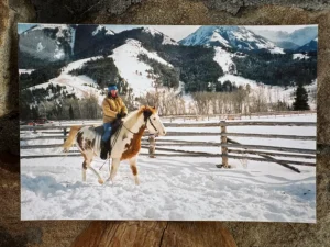 Maryanne rides a horse in the winter.